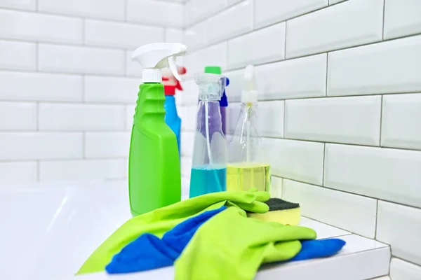 Detergentes guantes de trapo en el fondo de la pared de azulejos blancos, espacio de copia — Foto de Stock