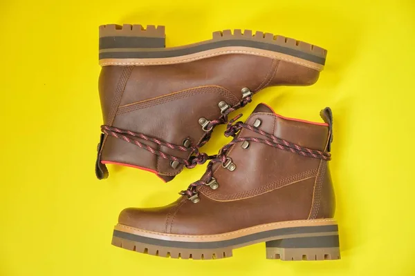 New womens leather brown waterproof winter boots on yellow background