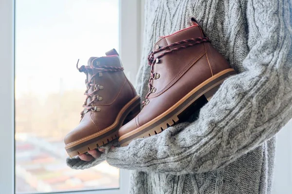 Nuevas botas de invierno impermeables marrones de cuero para mujer en manos de mujeres —  Fotos de Stock