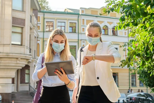 Mujeres de negocios que usan máscaras de protección médica con tableta digital —  Fotos de Stock