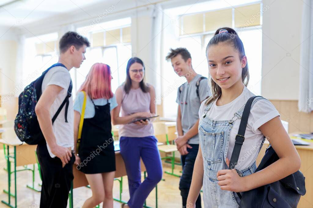 Portrait of smiling teenage girl in class on break