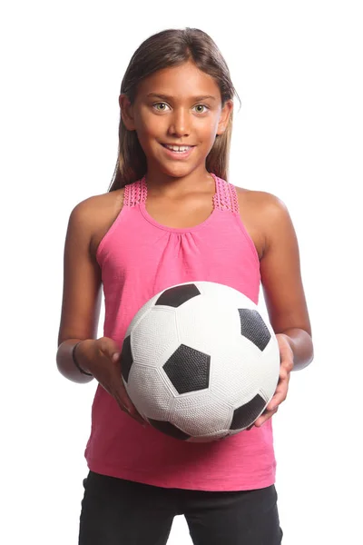 Menina da escola de raça mista alegre com bola de futebol Fotografia De Stock