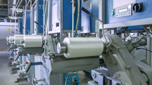 Timelapse Large White Synthetic Fiber Bobbins Turn Fast Conveyor Modern — Stock Video