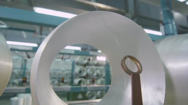 Closeup threads pass through guiding ring at plant — Stock Video