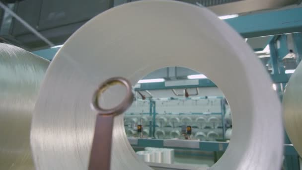 Closeup optical fiber unwinds passing through ring — Stock Video