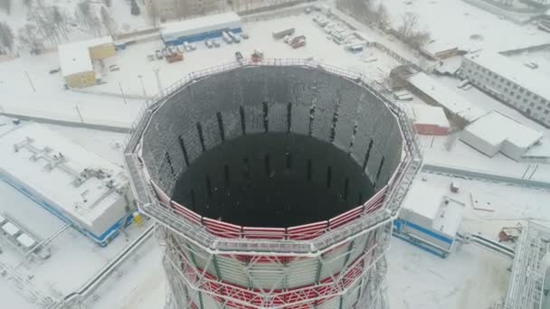 Cooling tower top among heating station area on snowy day — Stock Video