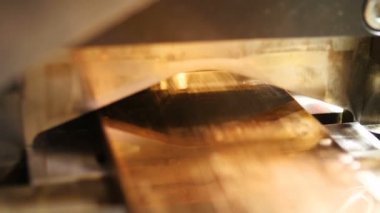 kesici iner ve sarı metal parçaya böler