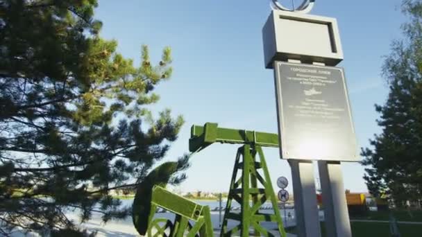 Velho monumento bomba jack perto da praia da cidade por pinheiros pictóricos — Vídeo de Stock