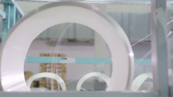 Close view through bobbin hole employee checks fiberglass quality — Stock Video