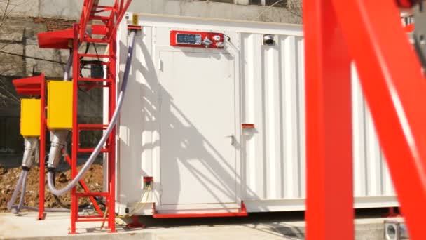 Modern electrical substation and red supports on foreground — Stock Video