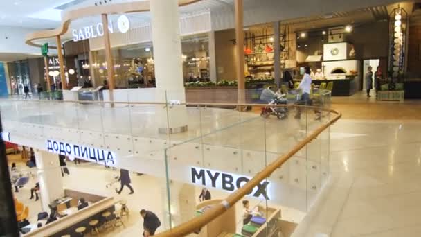 Движение вдоль нового торгового центра с красивыми кафе и магазинами — стоковое видео