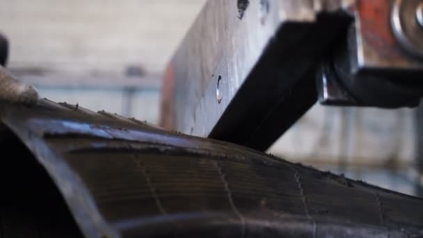 Close view huge metal knife cuts old truck tire into parts — Stock Video