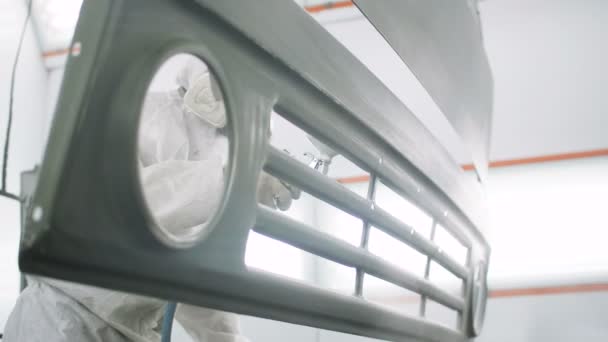 Arbeiter im Schutzanzug, der Details mit khakifarbener Farbe überzieht — Stockvideo