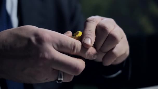 Closeup mature man sculpts with bright yellow plasticine — Stock Video