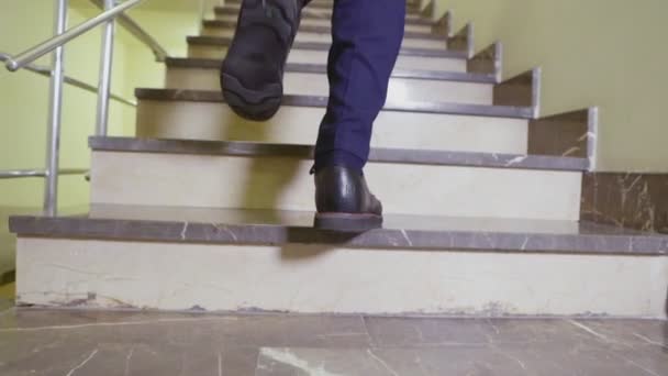 Man goes up stairs slow motion low angle shot closeup — Stock Video