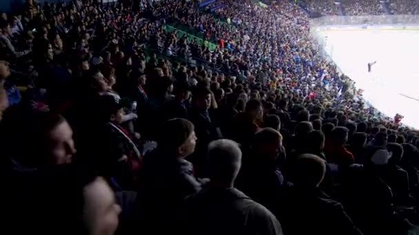 Hockey fans crowd watch game of famous teams on stadium — Stock Video