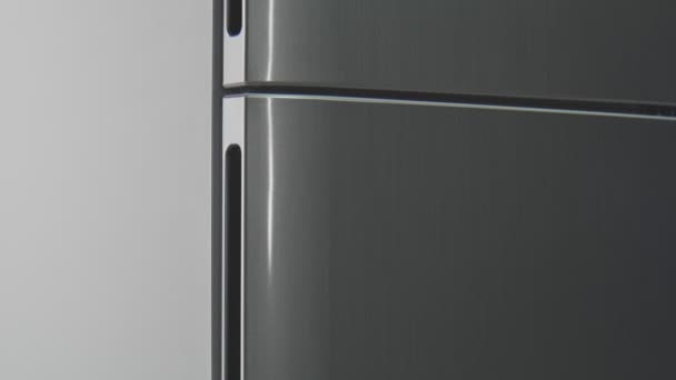 Motion along modern grey refrigerator with closed doors — Stock Video