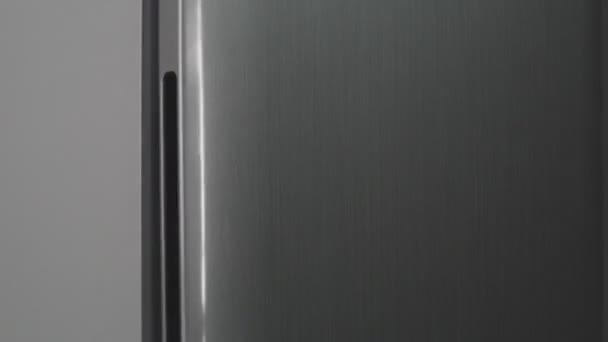 Grey refrigerator full of food with opening and closing door — Stock Video