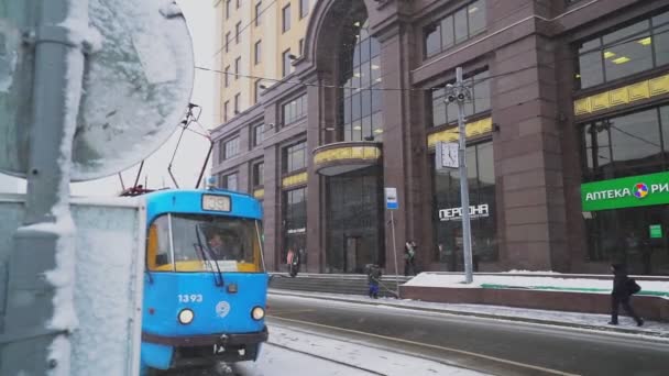 Značkové tramvaje kolem moderního obchodního centra při sněžení — Stock video