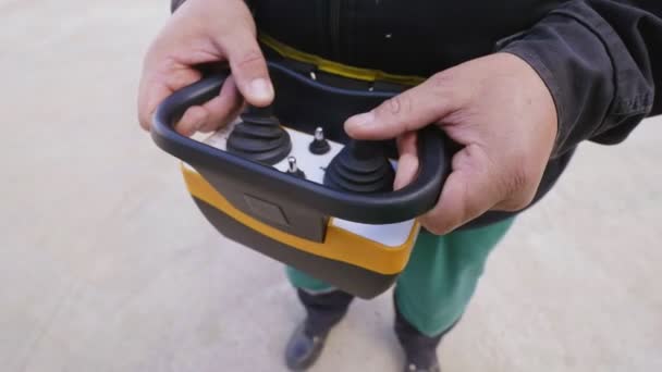 Man operates with joysticks of remote controller closeup — Stock Video