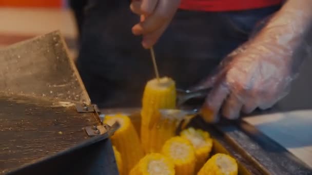 Man takes and adds salt to boiled corn in cafe closeup — Stock Footage Man takes and adds salt to boiled corn in cafe closeup Stock Video