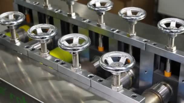 Production line with rollers and levers operates in shop — Stock Video