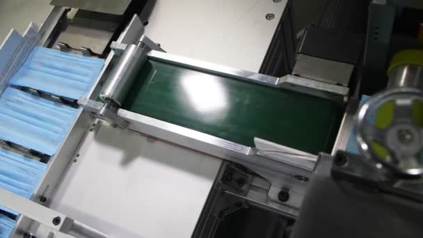Production line transports fabric sheets for medical masks — Stock Video