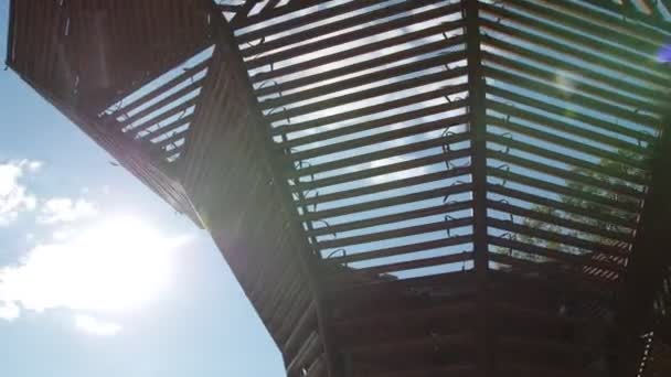 Pergolato di legno con tavole sottili contro cielo blu con nuvole — Video Stock