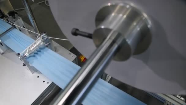 Оборудование делает складки на голубой ткани для одноразовых масок — стоковое видео