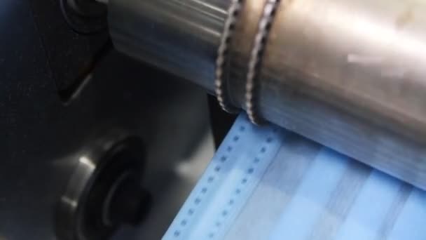 Metal roller works with rims of fabric strip for masks — Stock Video