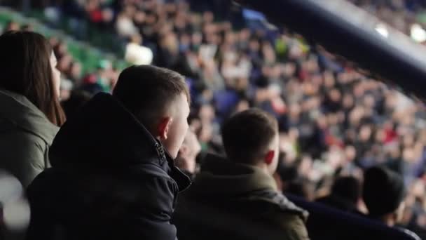 Sportovní fanoušci v teplém oblečení sledovat hokejový zápas na stadionu — Stock video