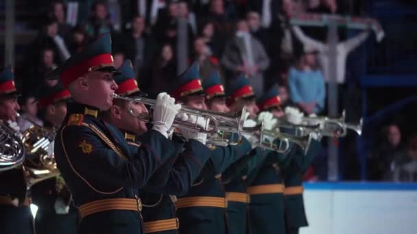 Military orchestra plays trombones performing on ice arena — Stock Video