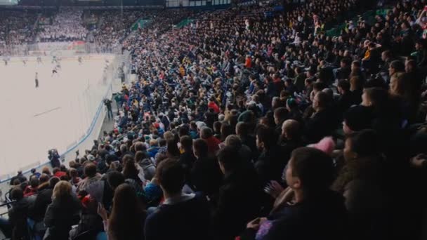 People watch hockey match from spectator places at stadium — Stock Video