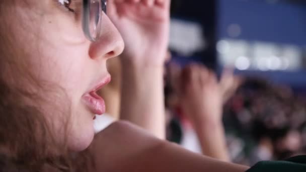 Kvinna med glasögon skriker och klappar händerna på hockeymatch — Stockvideo