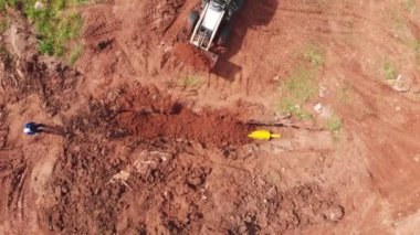 Kamyon, sarı metal boruyla delik açıyor.