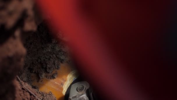 Dělník brousí plášť na potrubí s ručním nástrojem v příkopu — Stock video
