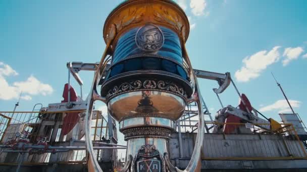 Cup with Yuri Gagarin portrait on ground against pump jacks — Stock Video