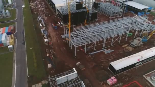 Truck crane stands near metal carcass at construction site — Stock Video