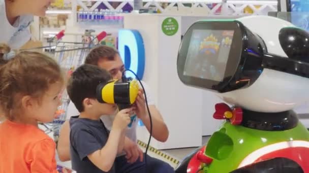 Boy with virtual reality headset plays video game in mall — Stock Video