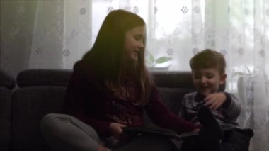 Çocuk bir kitap değerlendiriyorlar. Bulanık film 