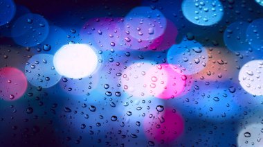  Rainy day. Raindrops on a blurred multicolored bokeh background