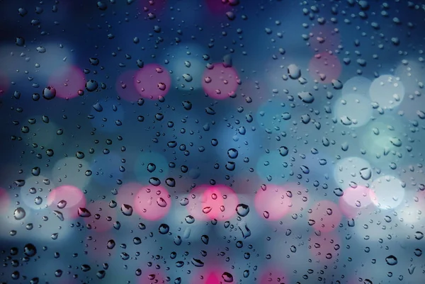 Giornata piovosa. Gocce di pioggia su uno sfondo bokeh multicolore sfocato — Foto Stock