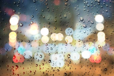  Rainy day. Raindrops on a blurred multicolored bokeh background