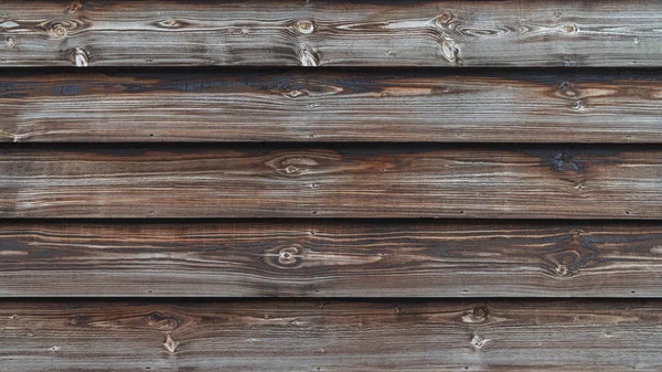 Textur einer alten dunklen, unbemalten Wand aus Holzbrettern — Stockfoto