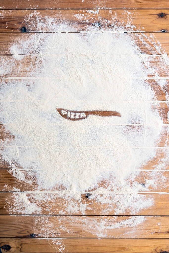 Flour scattered on the wooden table. Flour on the table surface. Baking  background 