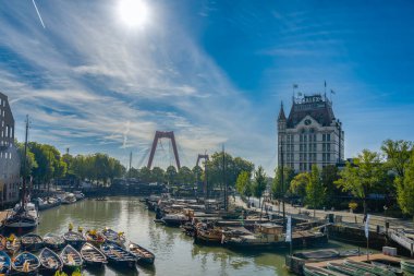 Rotterdam Hollanda - 06.09.2025, Beyaz Saray ve Rotterdam 'daki Willemsbrug köprüsünün manzaralı manzarası, nehir kenarındaki gezinti alanından taş balustrade ile görüldü..