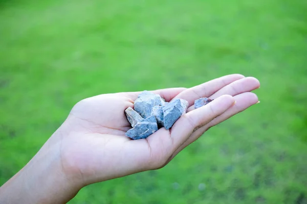 Woman hands holding small stones in hands