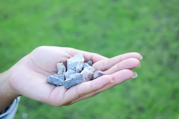 Woman hands holding small stones in hands