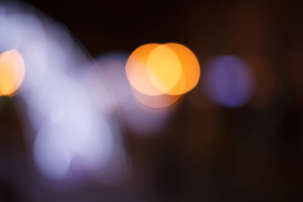 Night walk around the city. Decoration of streets with garlands and lanterns. Night city photo bokeh.