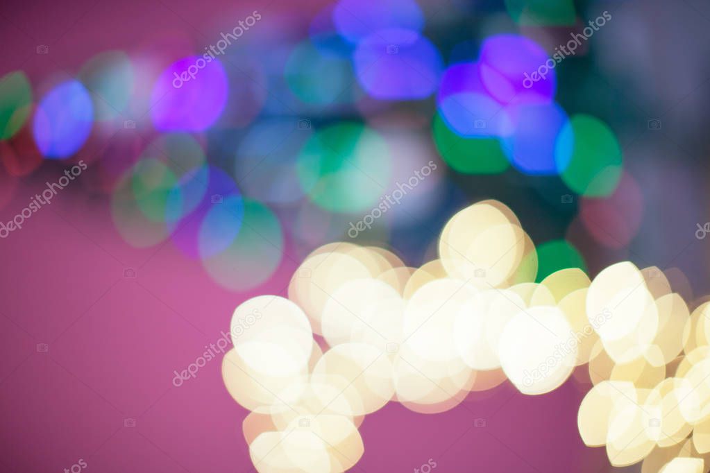 The Christmas tree is lit in different colors. Blurred background of the new year holiday